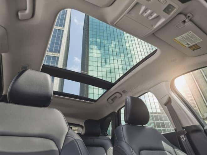 Cityscape shown from the inside of a Ford Escape interior moonroof.