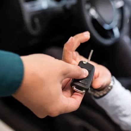close up image of an employee handing car keys to a customer