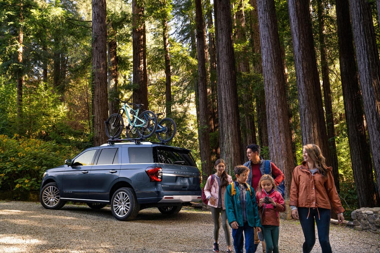 family in the forest with their 2022 Ford Expedition 