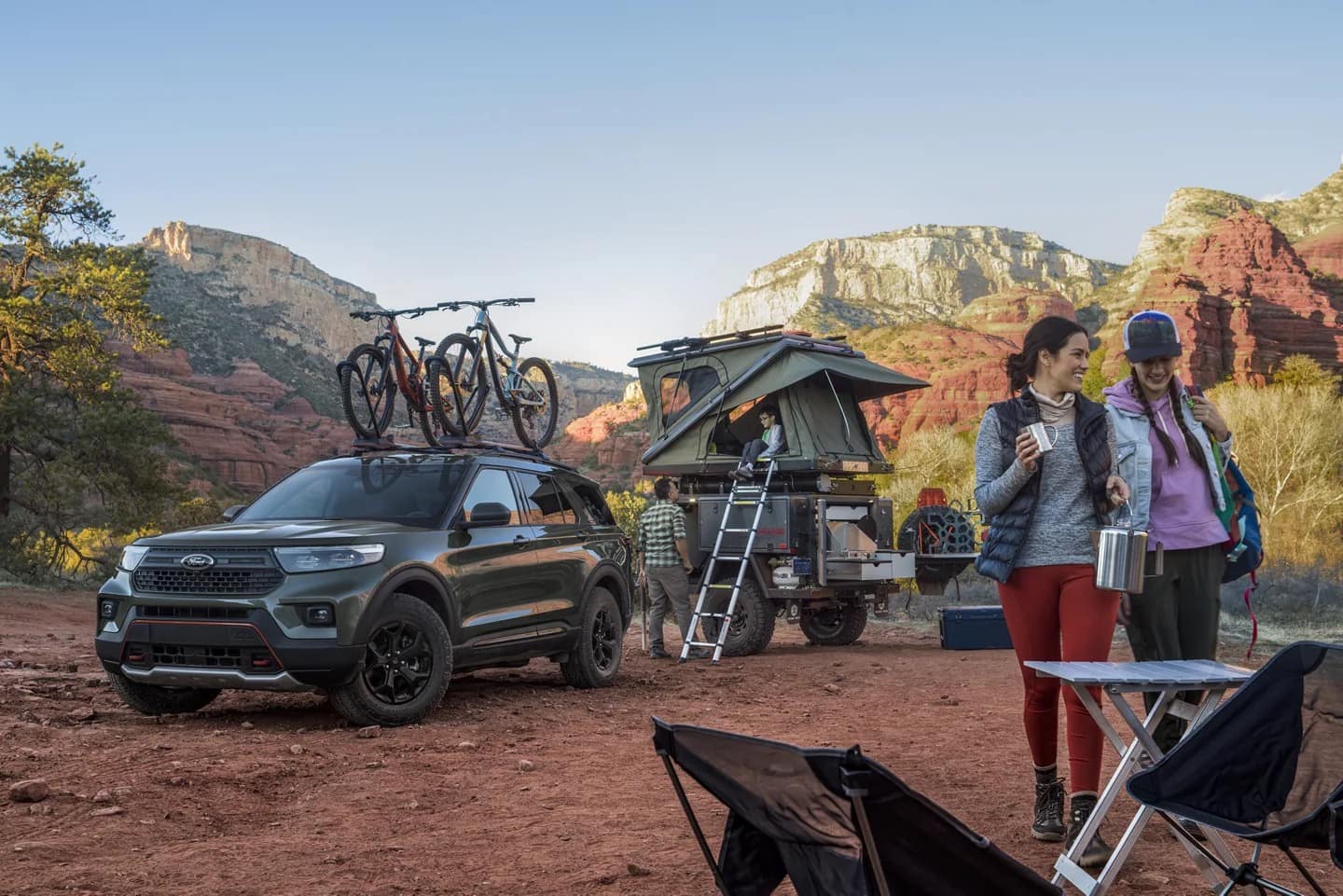 two women camping in the mountains with their 2022 Ford Explorer 