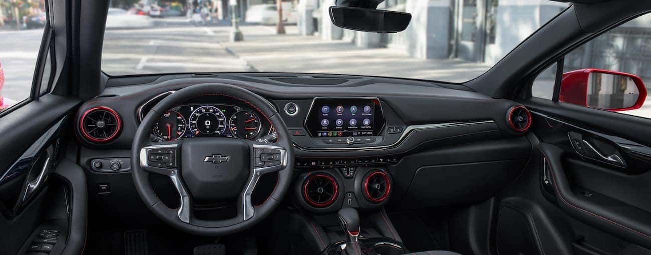 The black and red dashboard and infotainment features are shown.
