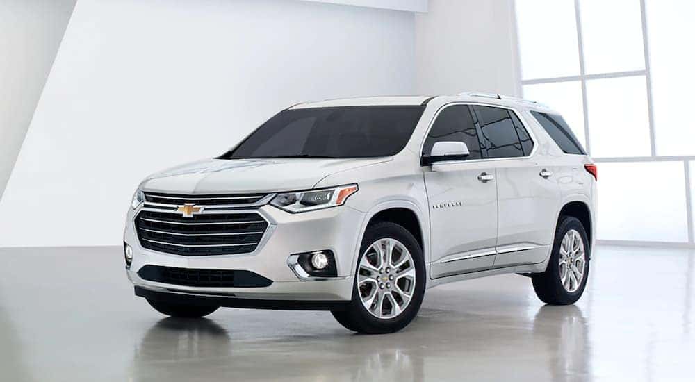A white 2020 Chevy Traverse is parked in a bright showroom at an Anderson Chevrolet dealer.