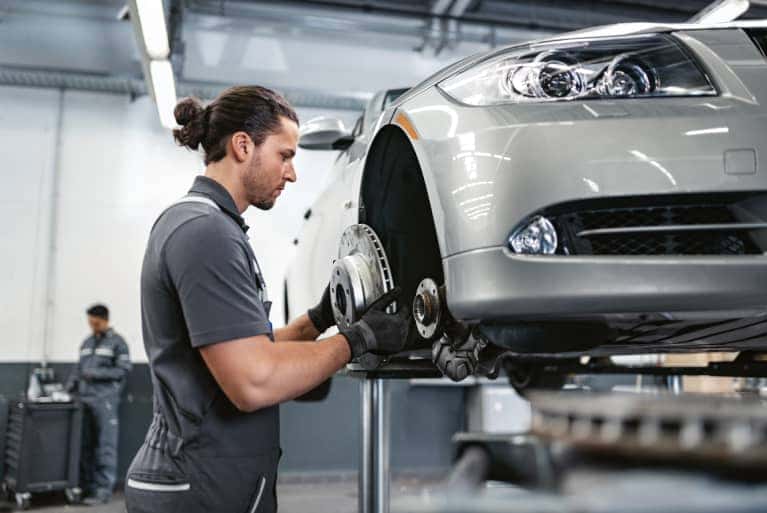 BMW Service Technician working on brakes