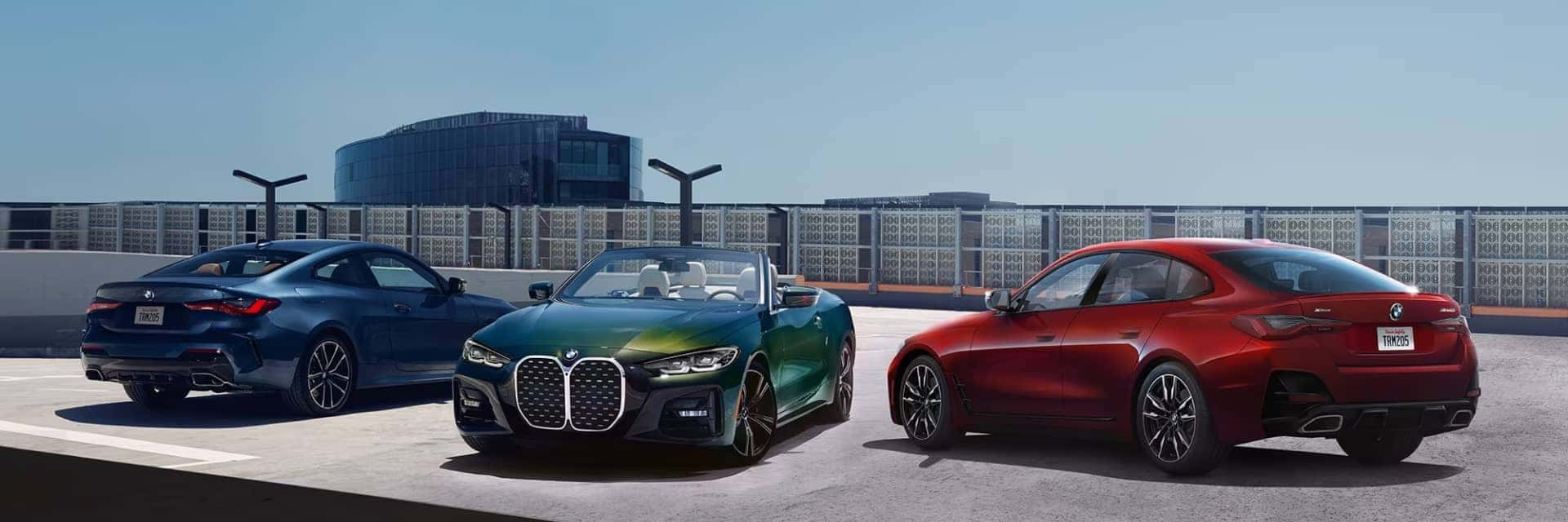 Three BMW 4 Series vehicles parked on a roof top parking lot