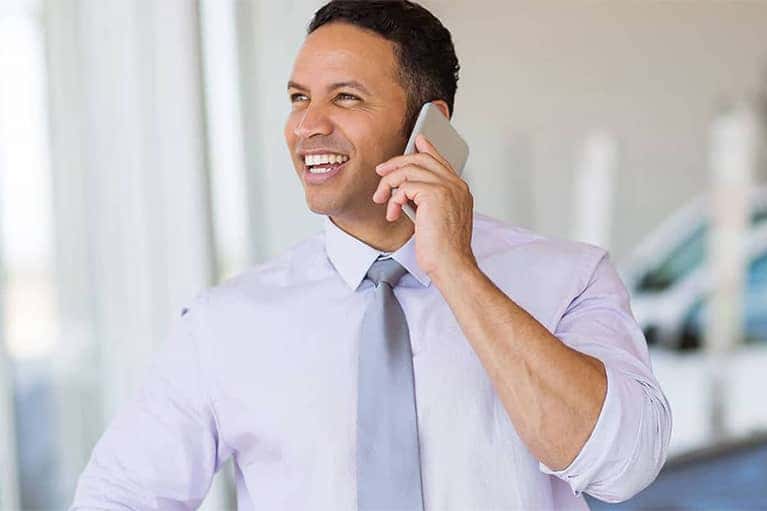 Man in Dealer Showroom Talking on Phone