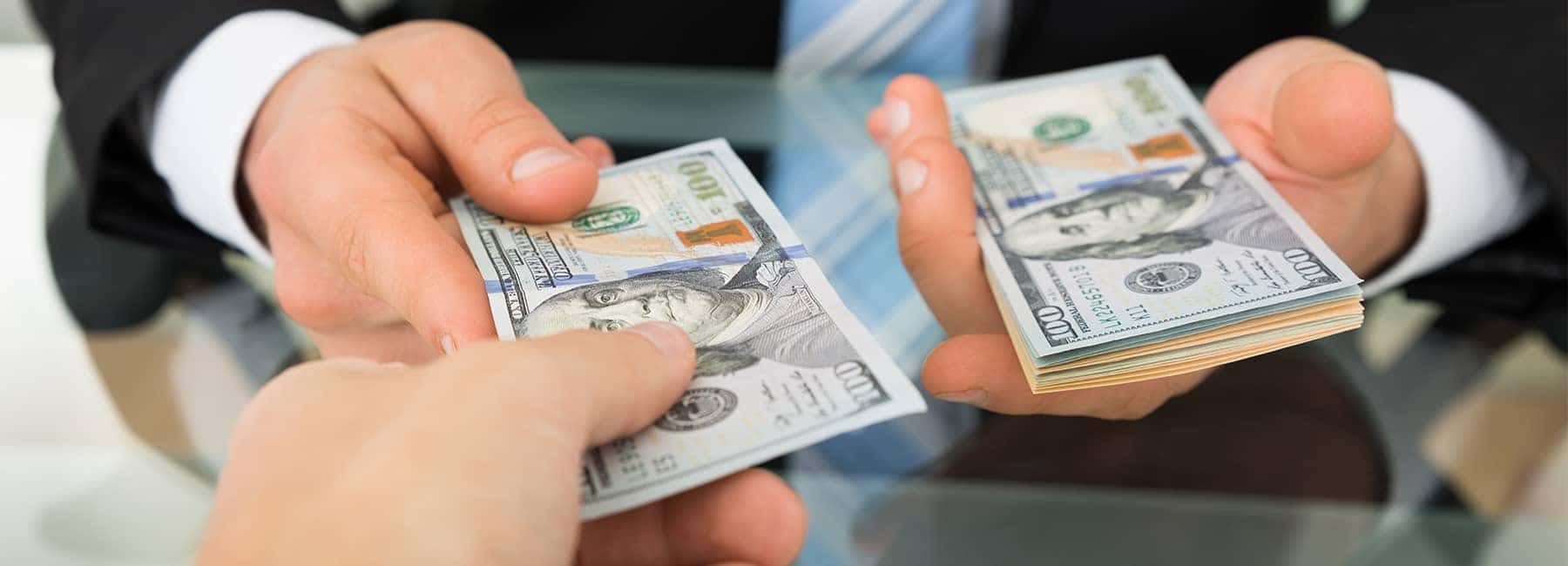 Person Handing Money to another Person