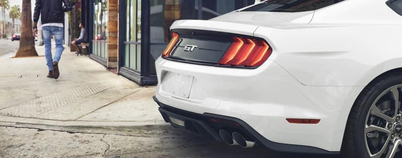 A close up shows the rear end of a white 2023 Ford Mustang GT.