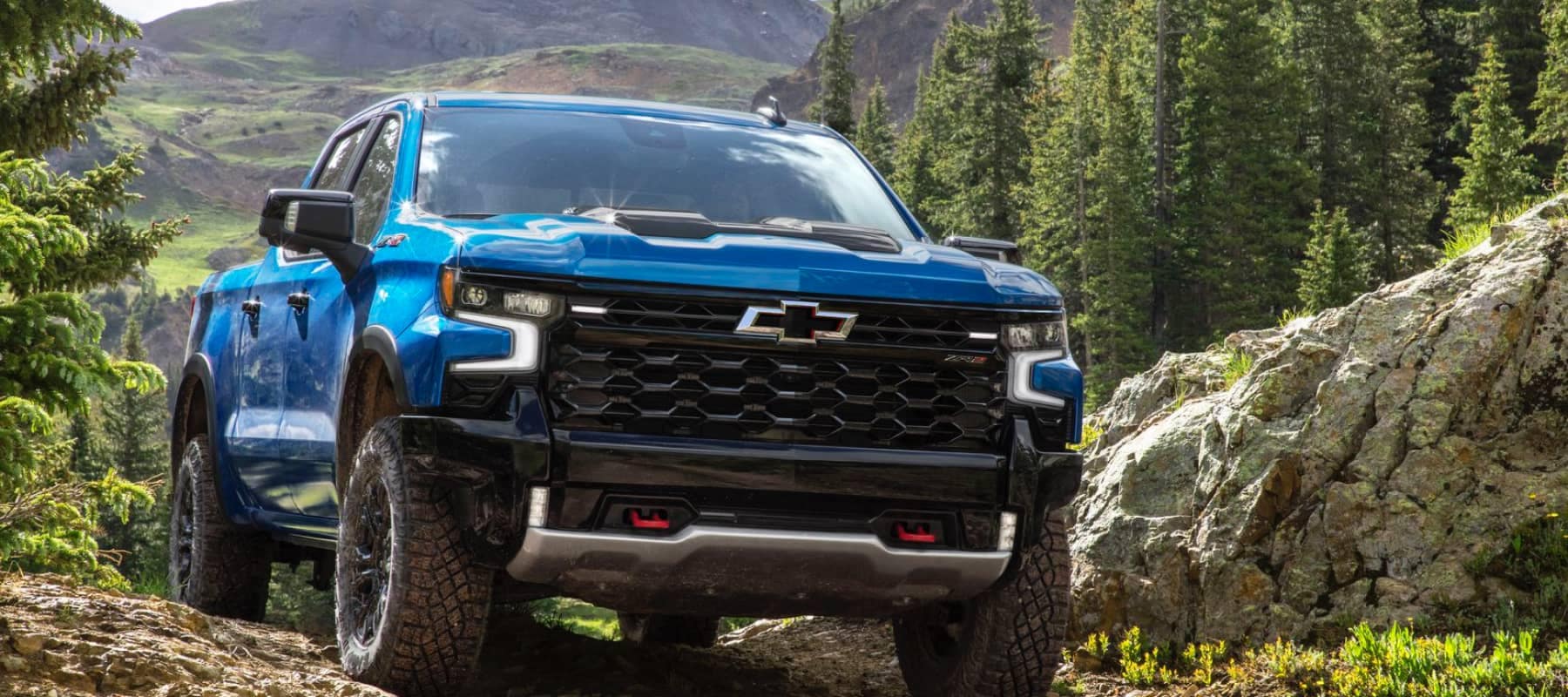 Blue Chevy Tahoe in the mountains - SEO Desktop image