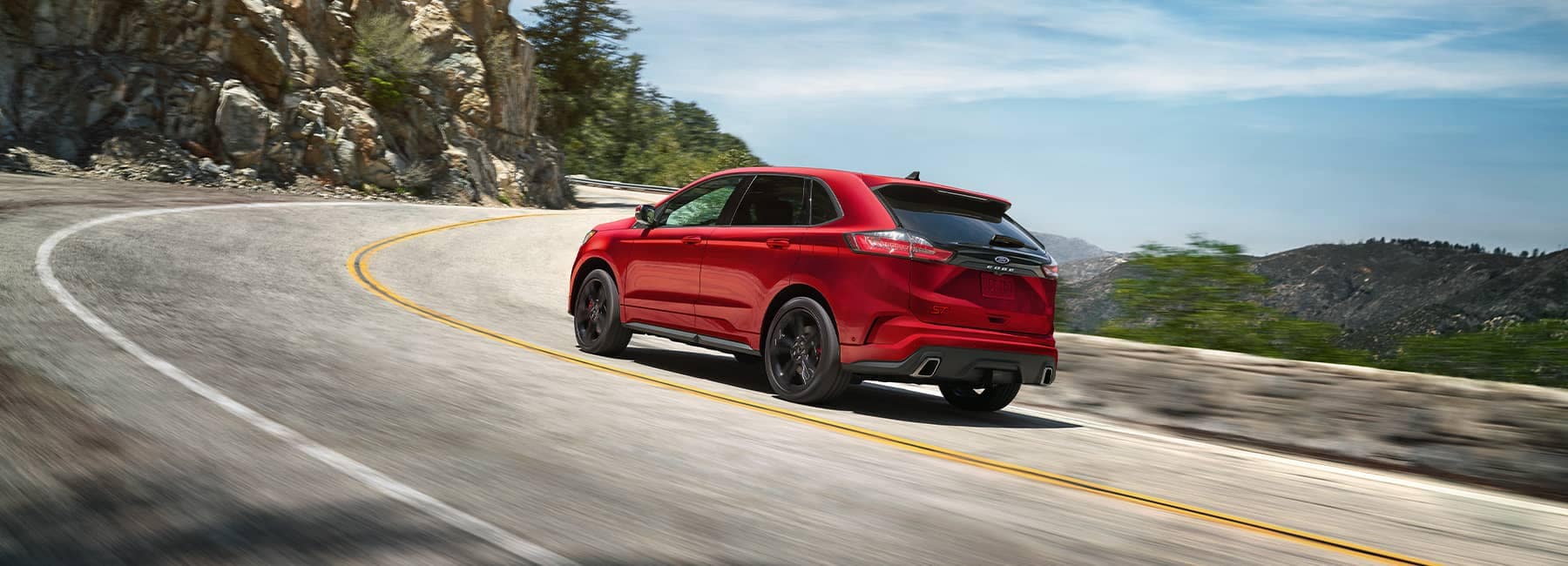 Red 2022 Ford Edge on a curving road