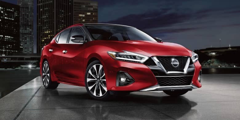 Angled front view of a red 2023 Nissan Maxima