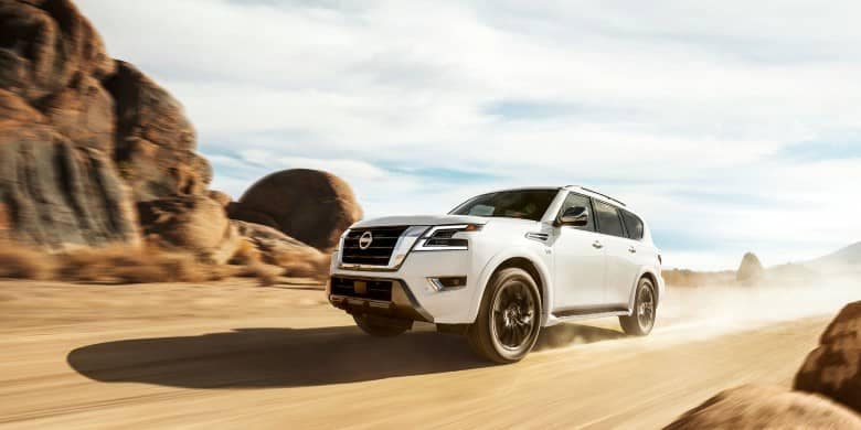 Angled view of a white 2023 Nissan Armada driving