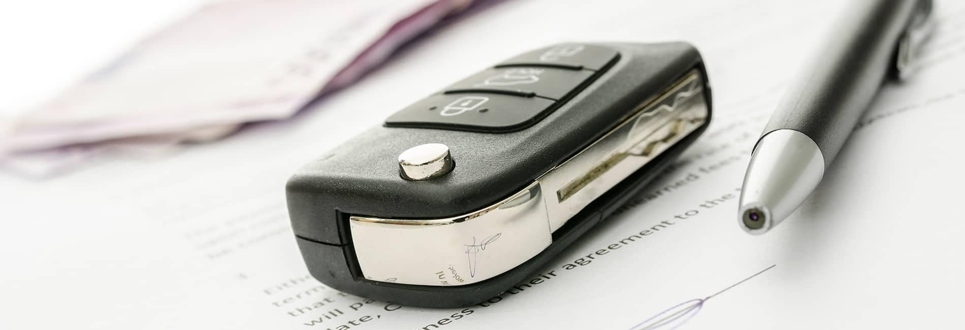 Vehicle key fob on top of a finance agreement