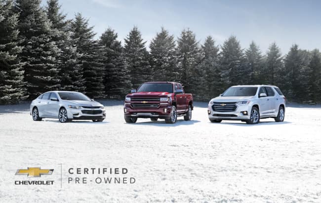 Three Chevrolet Cars lined up outside in the snow