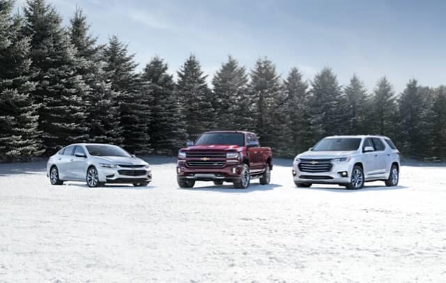 Three Chevy Vehicles parked in snow