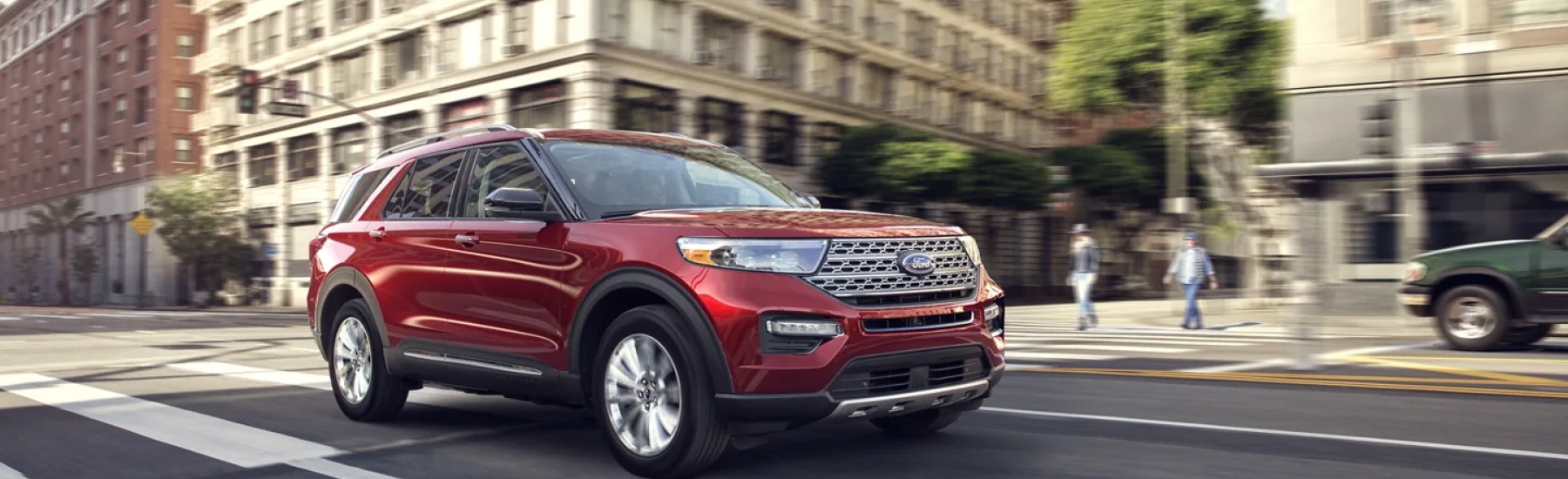 Red 2021 Ford Explorer driving in a city