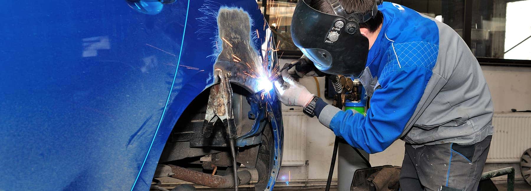 Body Shop Tech working on vehicle
