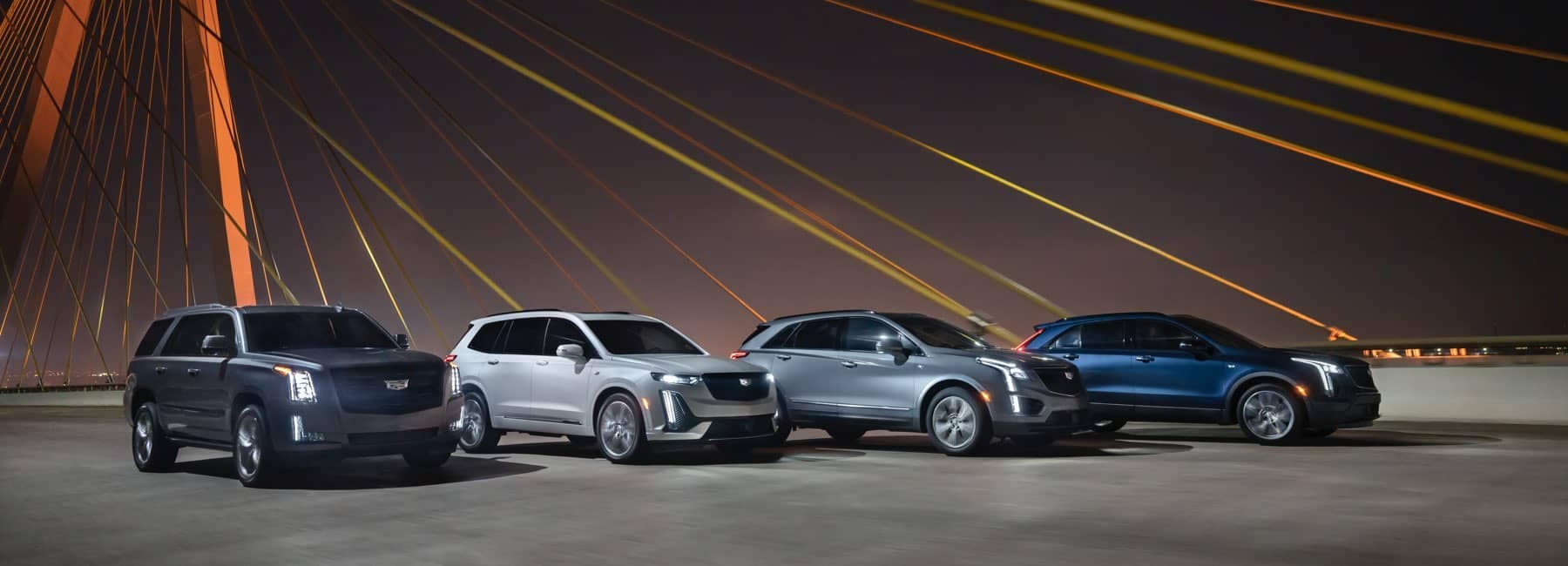 2020 Cadillac line-up in front of bridge