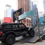 CDJR Jeep Wrangler Rubicon 329 Camp Jeep Sleek Black Jeep climbing steep mountain