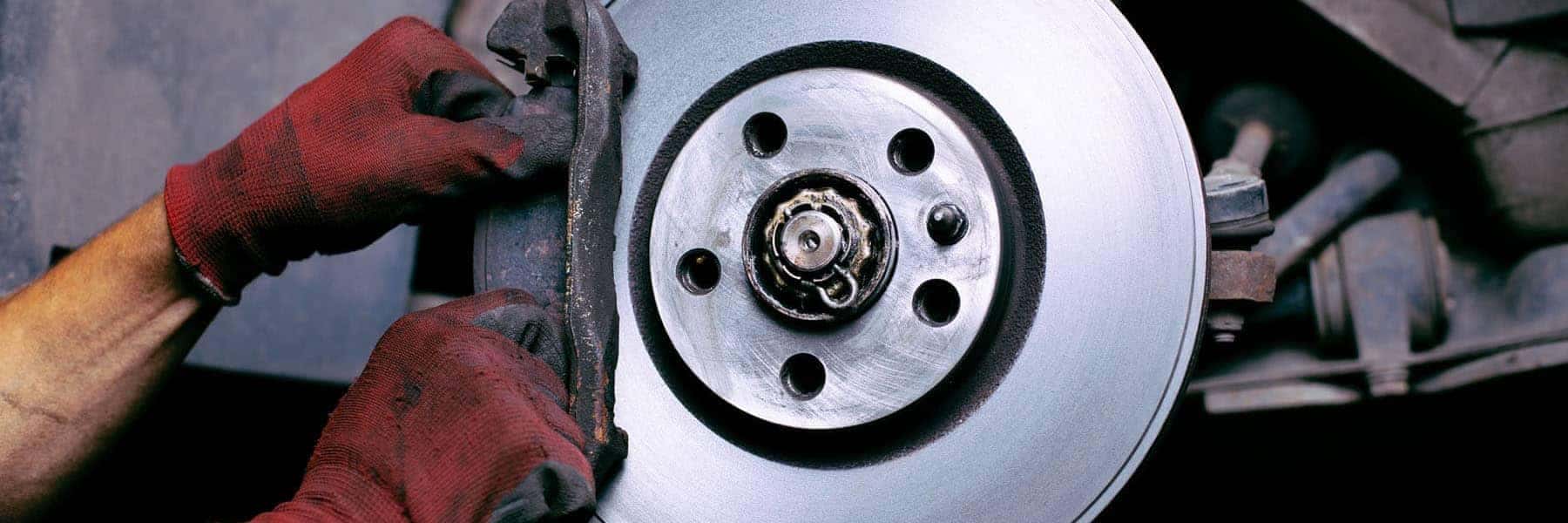 Mechanic Installing Car Brakes