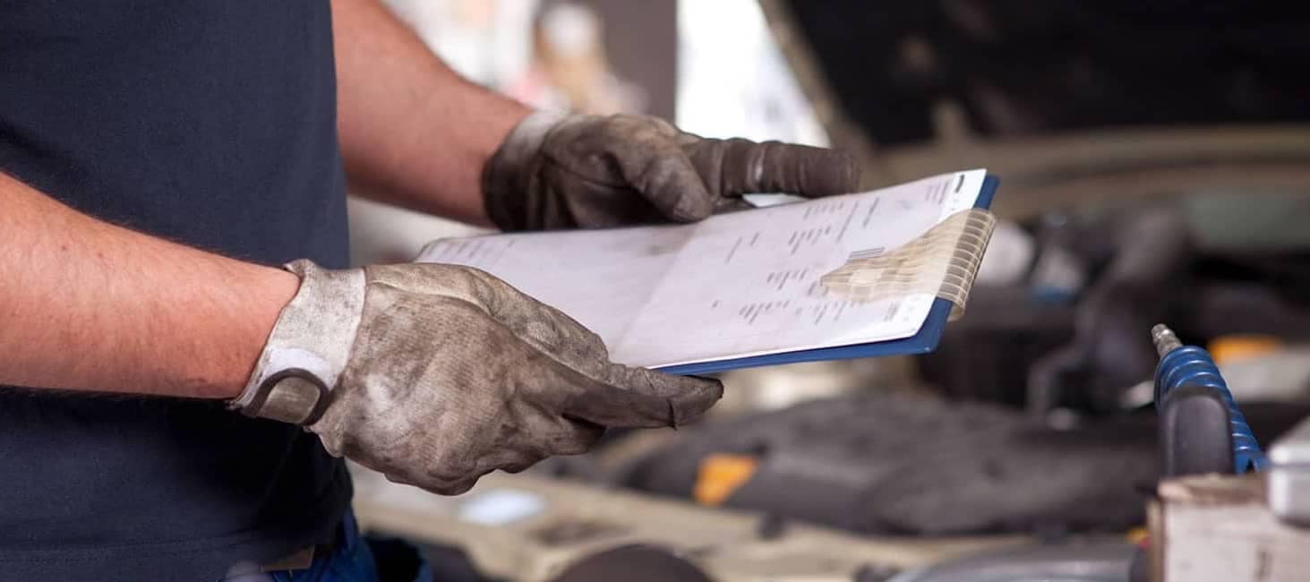 Mechanic with a Vehicle Inspection Checklist