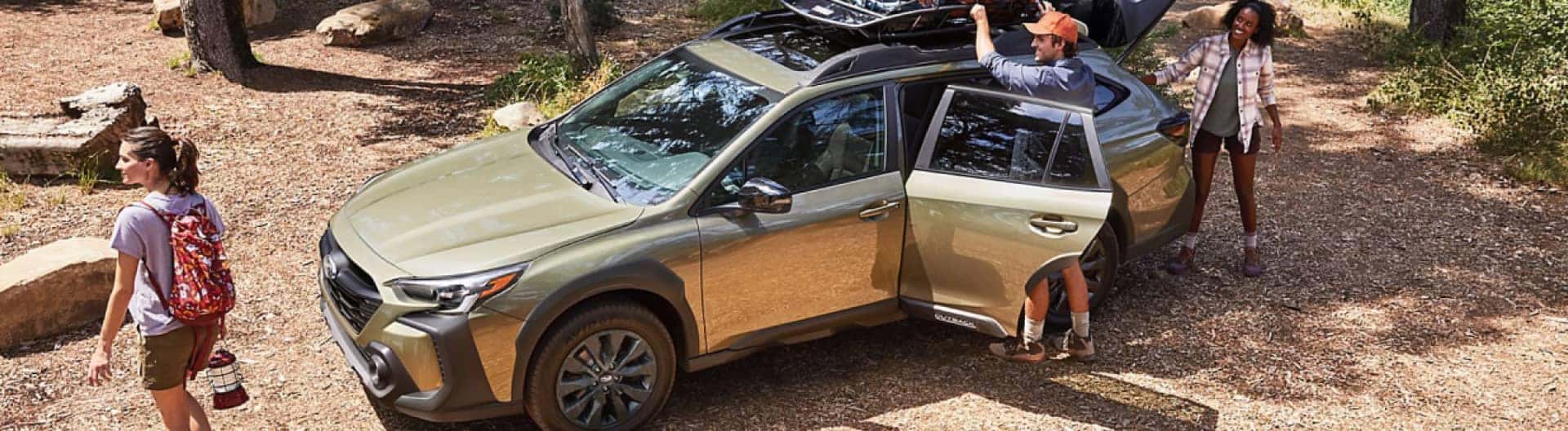 Family unpacking their Subaru on their camping trip