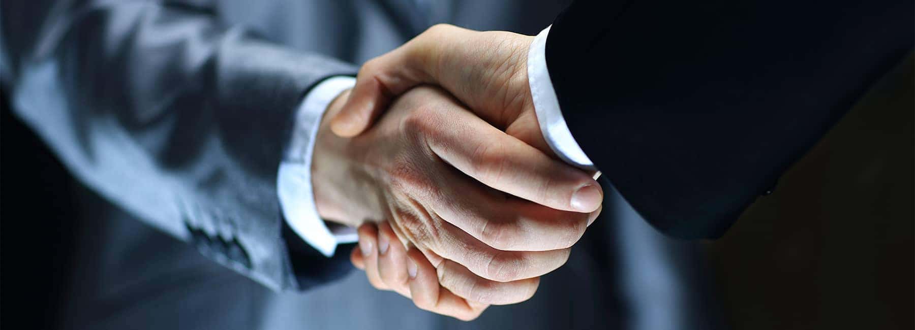 Businessmen in Suits Shaking Hands