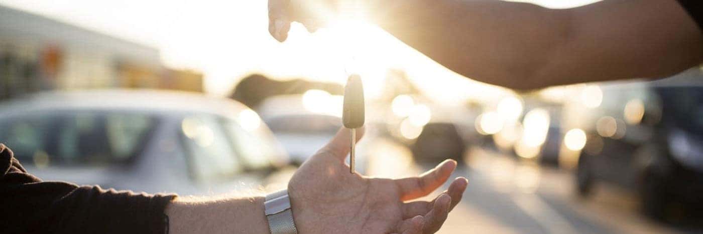 view of someone handing another person a set of car keys