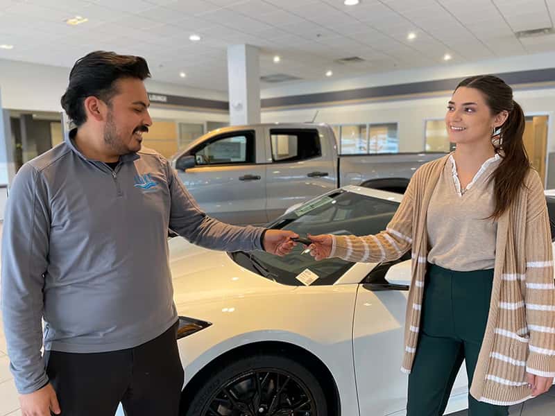 Lake-Auto-Group-car-salesman-giving-key-to-customer