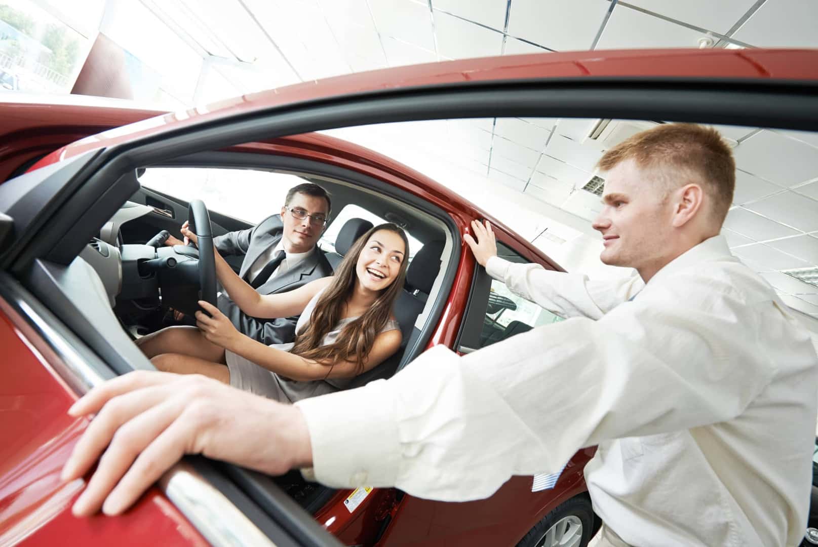 couple-looking-at-a-new-vehicle-with-finance-specialist