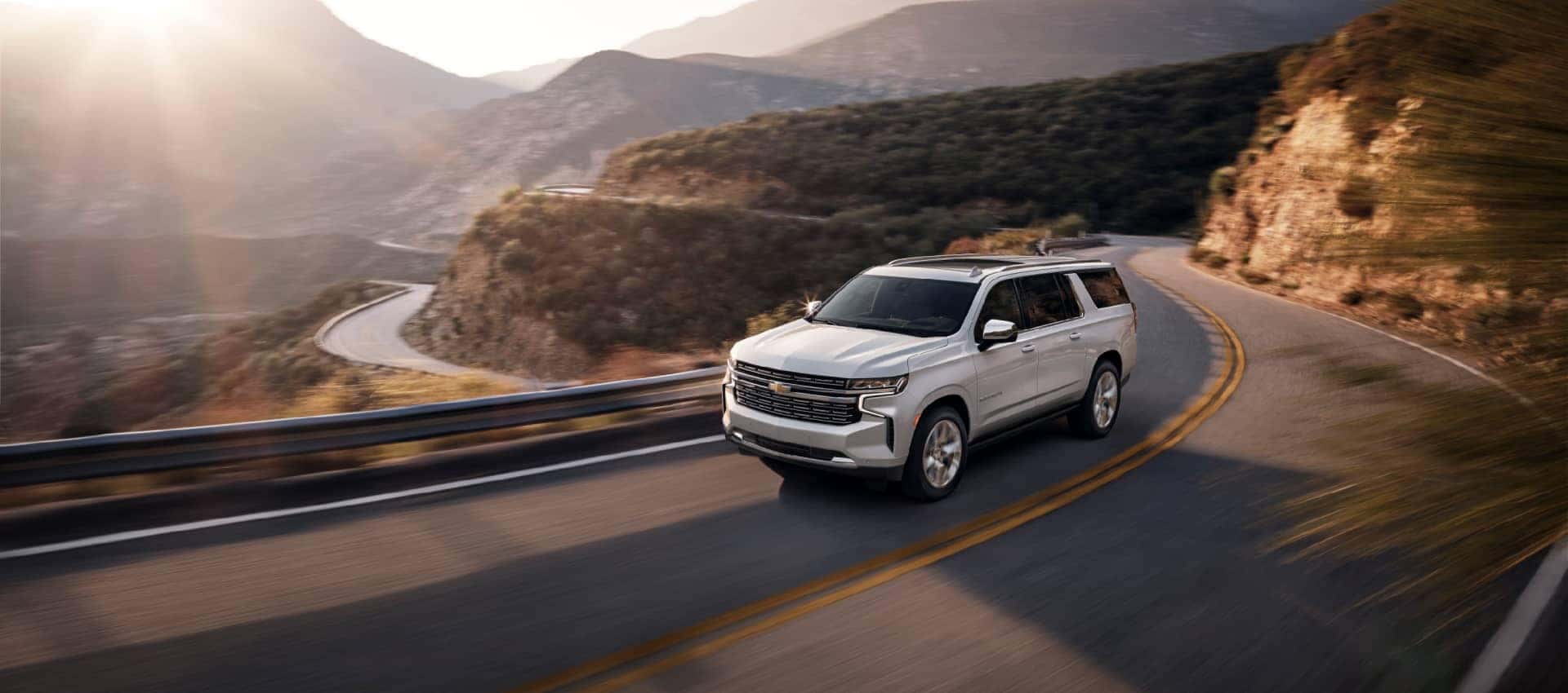 Chevrolet SUV driving on a winding road.