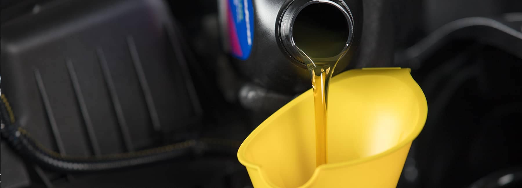 Oil pouring into car engine