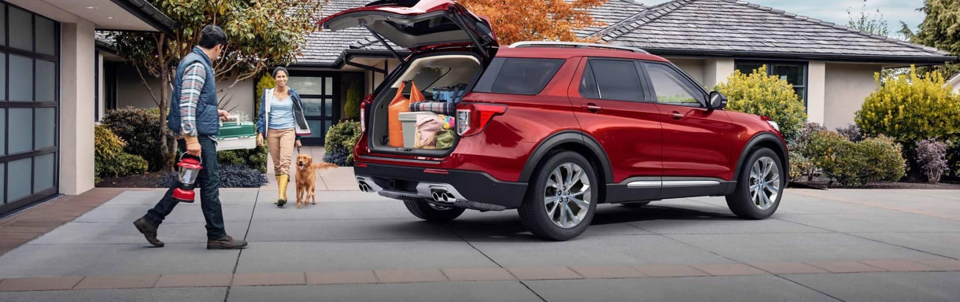 Red Ford SUV with a family packing up the tailgate