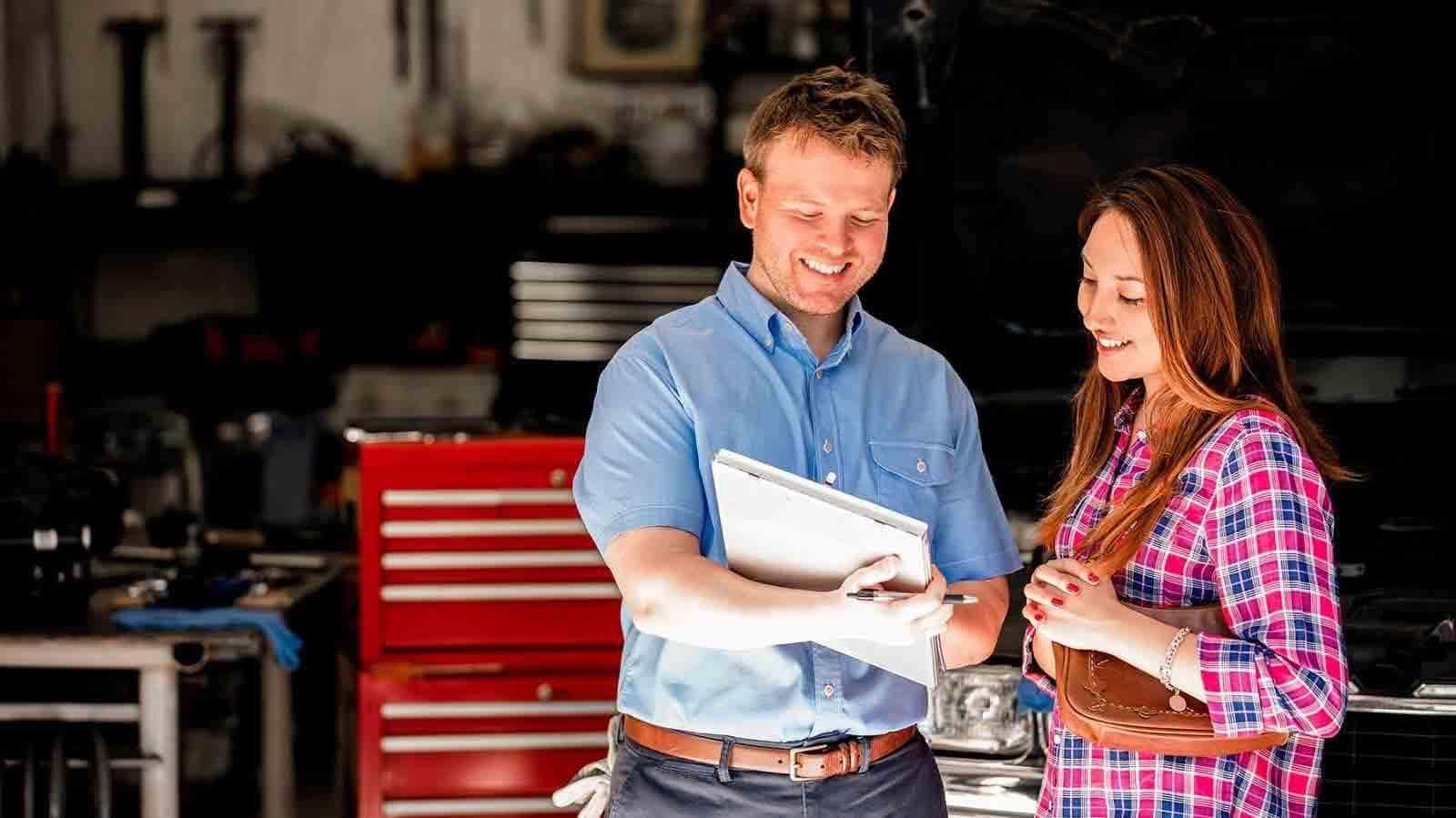 Mechanic showing client inspection