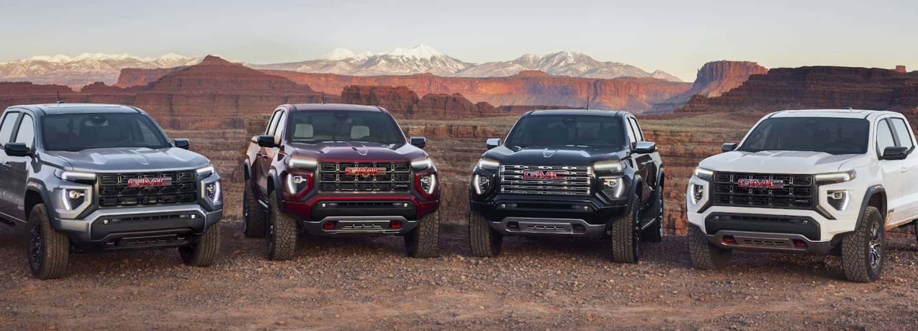 Group-of-2023-GMC-Canyon-trucks-parked-on-dirt-road_mobile