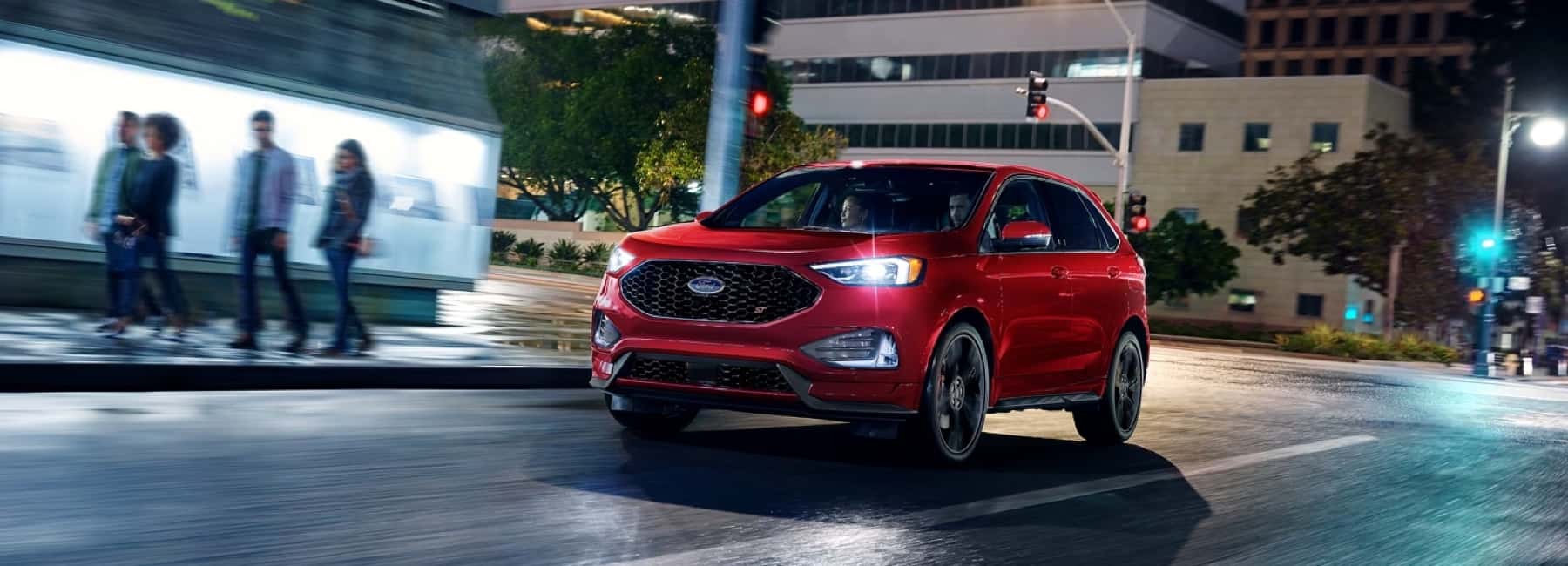2024-red-ford-edge-speedy-along-on-city-street-at-night
