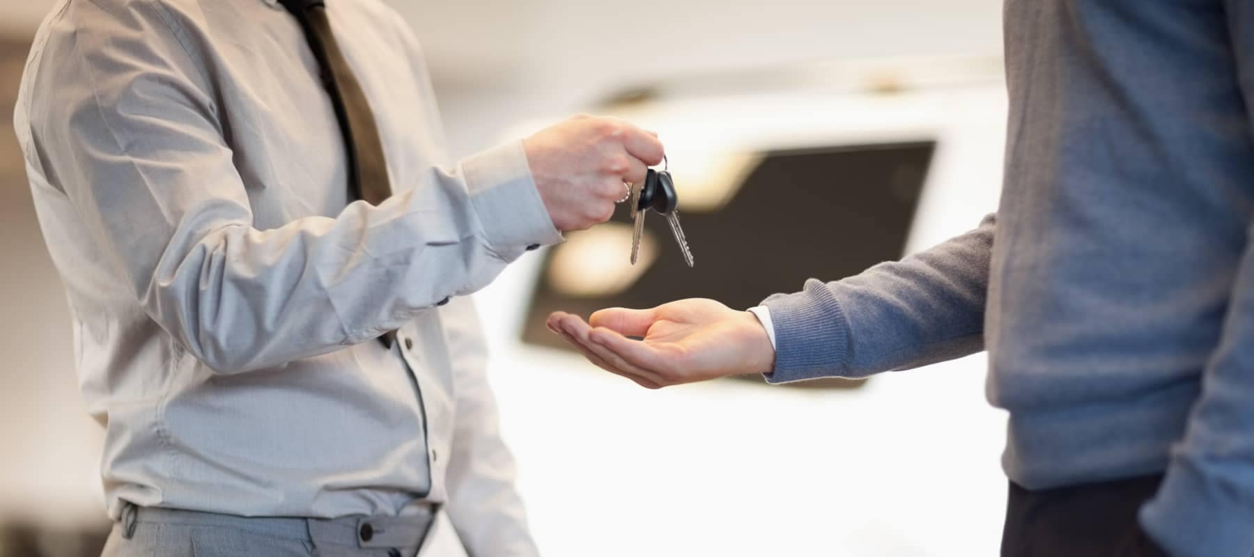 Person handing other person car keys