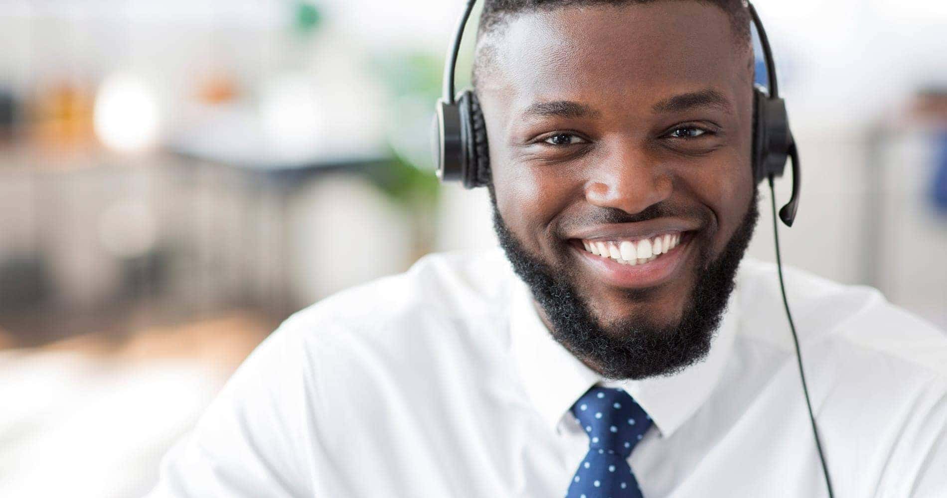 worker with a headset on and smiling