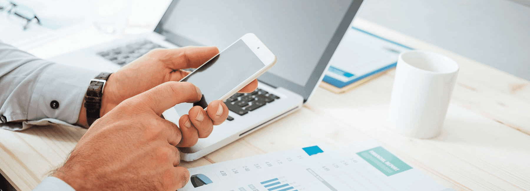 man-calculates-finances-with-smartphone
