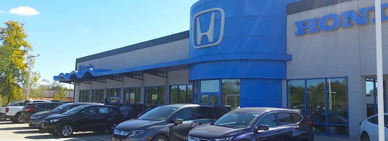 An exterior shot of a Honda dealership at night.