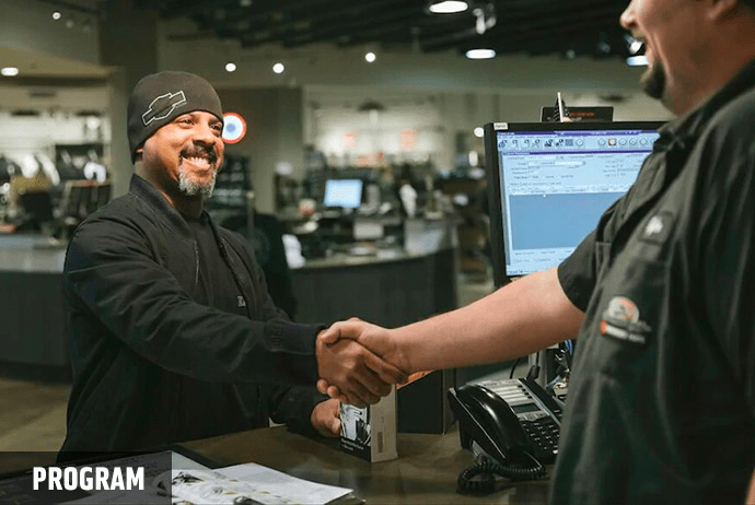 Harley-Davidson employee and customer shaking hands