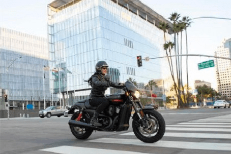 woman riding harley crossing intersection in the city
