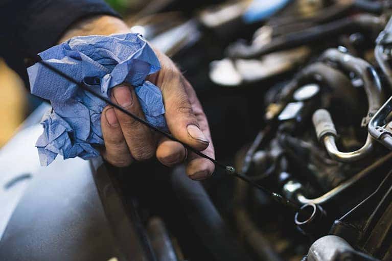 Car service mechanic working on automobile engine