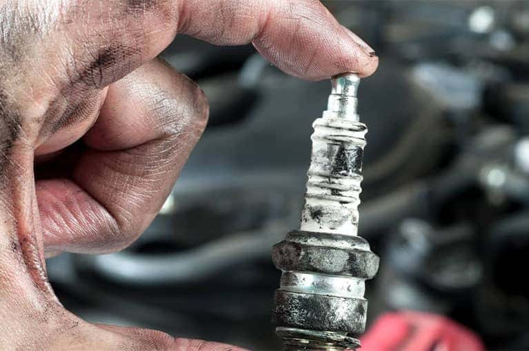 Mechanic holding a spark-plug