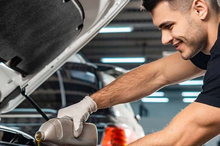 Mechanic pouring oil