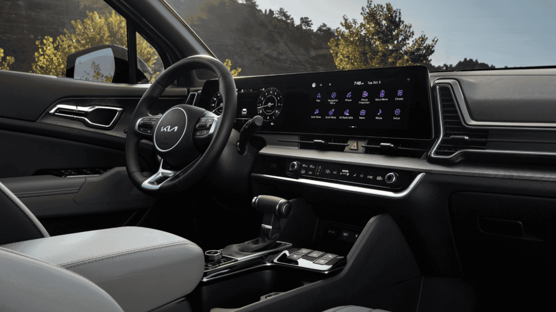 Close-up of the 2025 Kia Sportage interior showcasing the digital instrument cluster and large infotainment screen with navigation, climate control, and media features.