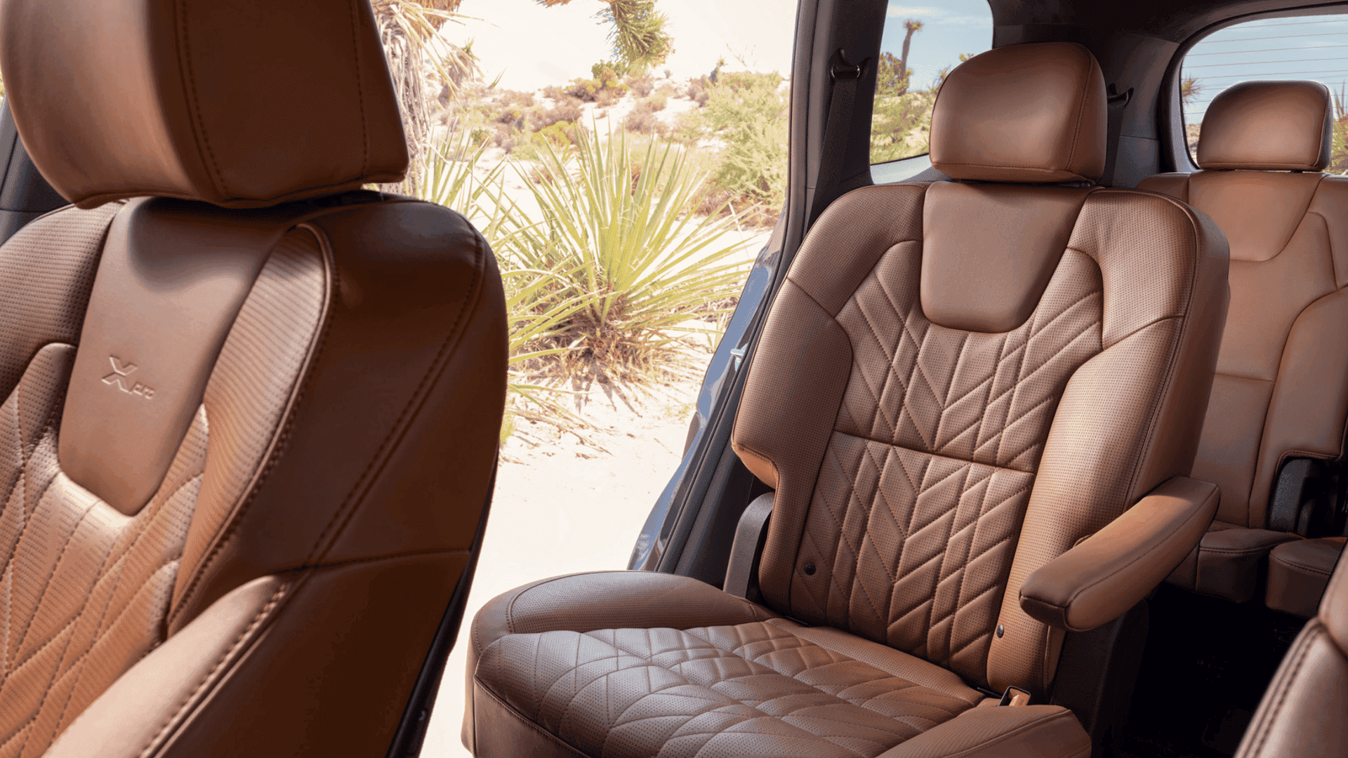 Close-up of the 2025 Kia Telluride's second-row captain’s chairs in quilted brown leather, offering luxurious comfort and spacious seating.