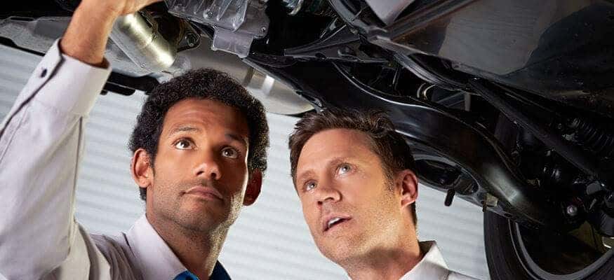 Mechanic Looking At Car