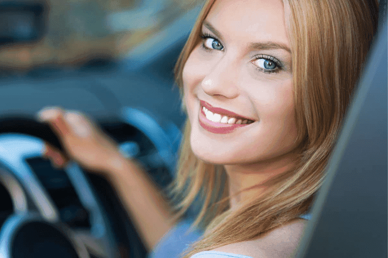 smiling-woman-driving-new-car