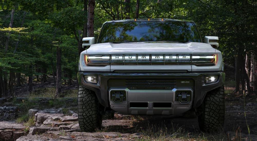 A white 2022 GMC Hummer EV is shown from the front while in the woods after leaving a GMC dealer in MS.