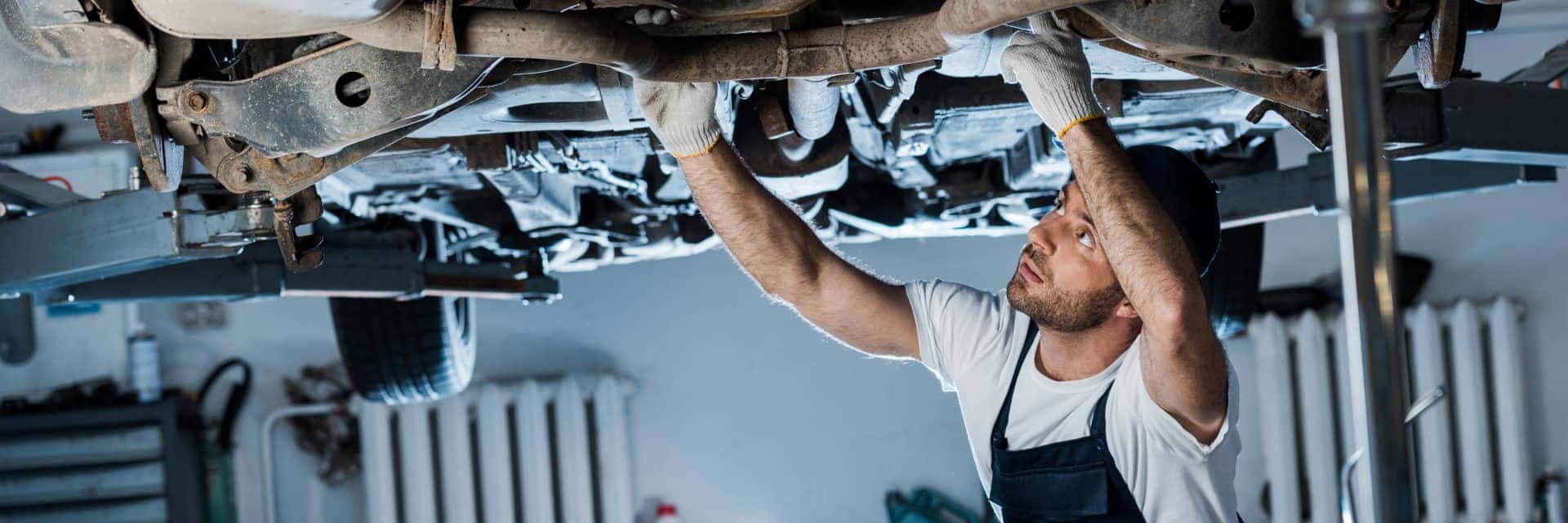 service specialist looking at undercarriage